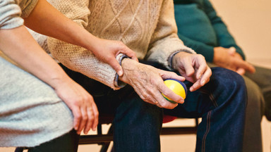 älterer Mensch, der einen Ball in der Hand hält